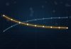 What Is an Inverted Yield Curve, and Does It Really Predict Recessions? Glowing gold line sloping downward across a dark blue grid, crossing a fainter blue line that slopes upward, illustrating an inverted yield curve