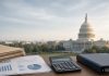 CBO Puts U.S. Iran War Cost to Pentagon Near $38 Billion, Warns of Inflation and Years to Rebuild Missile Stocks Wooden desk with folders, printed charts, and a calculator in front of a softly focused U.S. Capitol building