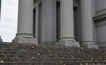 Jay-Z Accuser Recants Rape Allegation as Buzbee’s Lawyers Challenge Her Declaration Granite columns and stone steps of a courthouse on an overcast autumn day, with fallen leaves on the steps