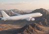 Flydubai FZ1073 Diverted to Tabuk After Cockpit Altercation as Israel Flights Are Suspended A plain white twin-engine passenger jet with no airline markings flying over rugged desert mountains in soft dawn light