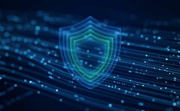 Google Gemini 4 Argon Launches First to Cyber Defenders Ahead of Wider Release A glowing layered blue and teal shield floating over streams of light particles on a dark blue background