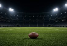Cowboys Agree to Trade for Steelers Cornerback Joey Porter Jr. A football resting on the grass of an empty floodlit stadium at night, with white yard lines and empty stands