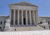 Supreme Court Opens Term With Boulder Climate Suit Against Exxon, Suncor Front view of the U.S. Supreme Court building with Corinthian columns and wide marble stairs
