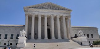 Supreme Court Opens Term With Boulder Climate Suit Against Exxon, Suncor Front view of the U.S. Supreme Court building with Corinthian columns and wide marble stairs
