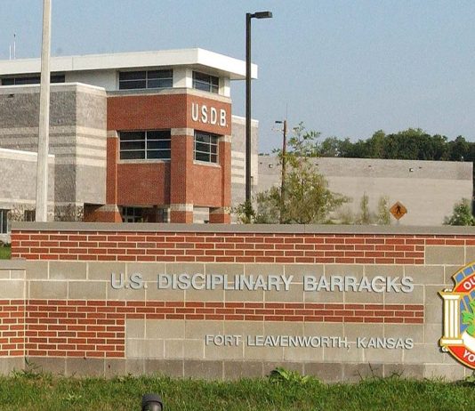 Trump Approves Firing Squad Execution for Fort Hood Shooter Nidal Hasan Entrance sign and main building of the U.S. Disciplinary Barracks at Fort Leavenworth, Kansas