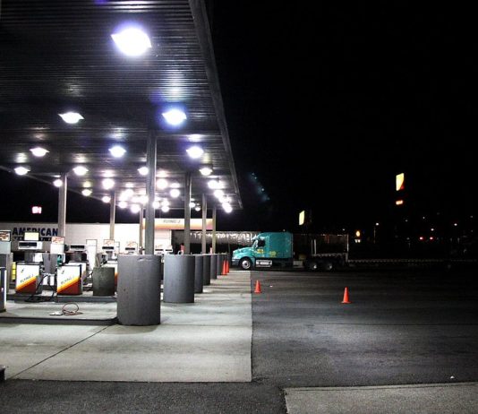 Trump Opens Red-Dyed Diesel to Highways, Defers Federal Tax Through Dec. 31 Diesel pumps under a lit canopy at a Flying J truck stop at night, with a semi-truck parked nearby