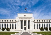 Fed Minutes: Most Officials Saw Another Rate Hike Likely by Year End Marriner S. Eccles Federal Reserve Board Building in Washington, D.C., with the U.S. flag flying above the entrance