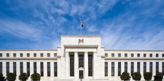 Fed Minutes: Most Officials Saw Another Rate Hike Likely by Year End Marriner S. Eccles Federal Reserve Board Building in Washington, D.C., with the U.S. flag flying above the entrance