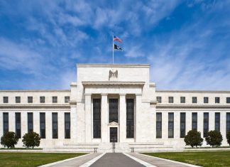 Fed Minutes: Most Officials Saw Another Rate Hike Likely by Year End Marriner S. Eccles Federal Reserve Board Building in Washington, D.C., with the U.S. flag flying above the entrance