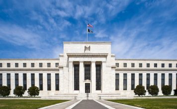 Fed Minutes: Most Officials Saw Another Rate Hike Likely by Year End Marriner S. Eccles Federal Reserve Board Building in Washington, D.C., with the U.S. flag flying above the entrance