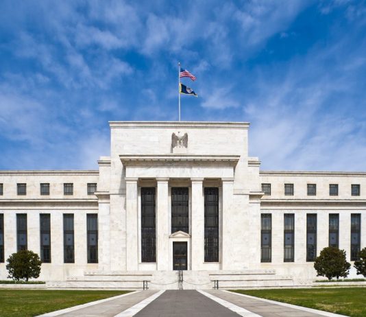 Fed Minutes: Most Officials Saw Another Rate Hike Likely by Year End Marriner S. Eccles Federal Reserve Board Building in Washington, D.C., with the U.S. flag flying above the entrance