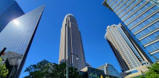 Bank of America Q3 Profit Falls 17% After $1.2 Billion Treasury Fine Bank of America Corporate Center tower rising above neighboring skyscrapers in uptown Charlotte, North Carolina