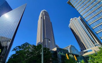 Bank of America Q3 Profit Falls 17% After $1.2 Billion Treasury Fine Bank of America Corporate Center tower rising above neighboring skyscrapers in uptown Charlotte, North Carolina