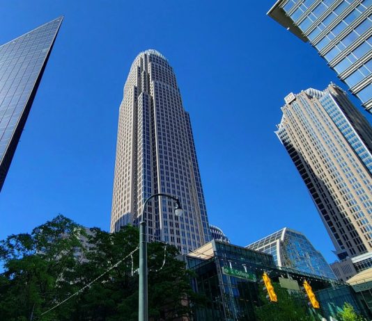 Bank of America Q3 Profit Falls 17% After $1.2 Billion Treasury Fine Bank of America Corporate Center tower rising above neighboring skyscrapers in uptown Charlotte, North Carolina