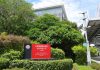 TSMC Q3 Profit Soars 69% to Record, Sees Q4 Sales Up to $54.3 Billion Red Taiwan Semiconductor Manufacturing Company sign outside TSMC Fab 14B in Tainan, Taiwan, with the fab building behind trees